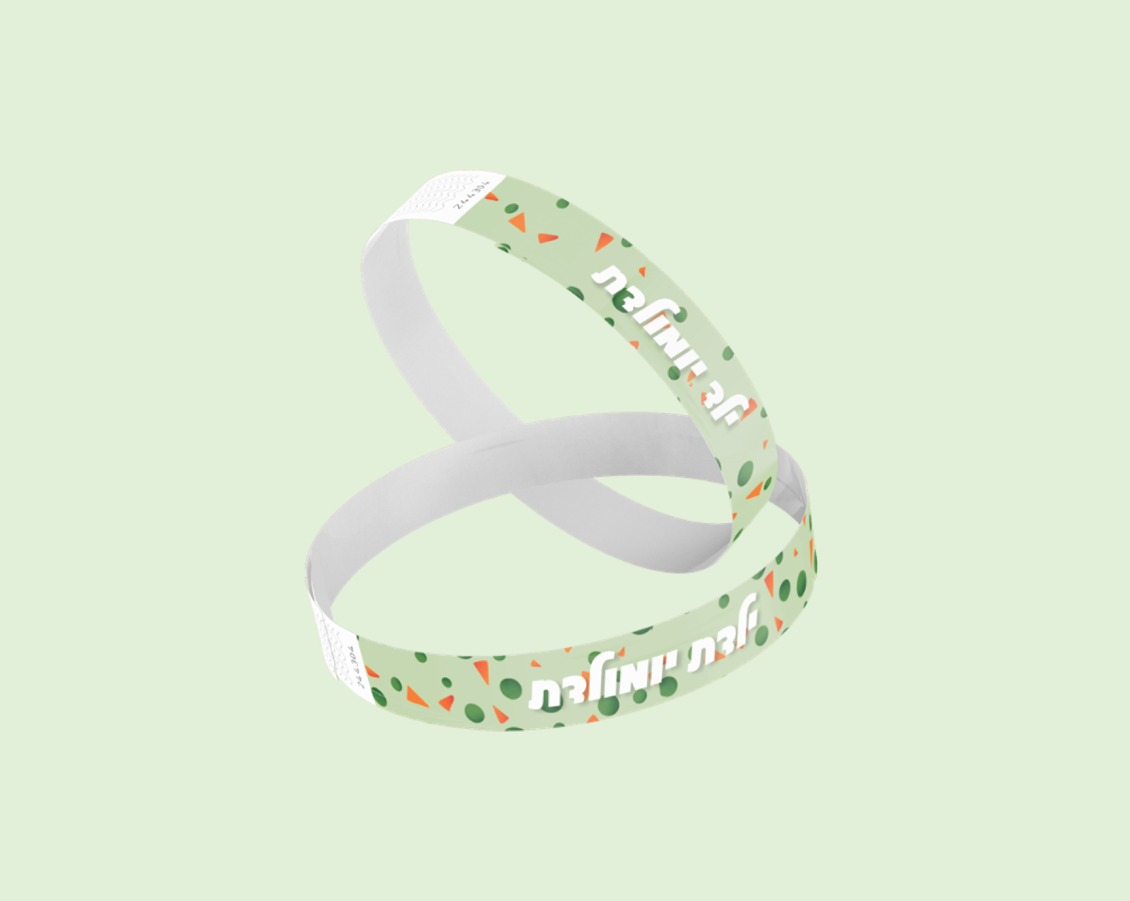 An entry wristband printed with the brand pattern of green dots and orange triangles and the event wordmark